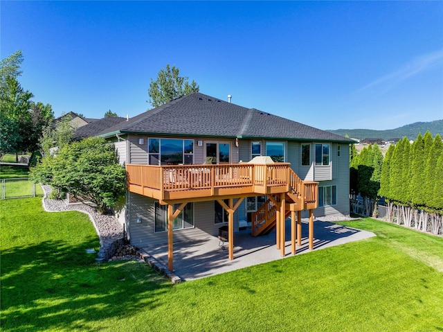 3640 Jack Dr, Missoula, MT 59803 - back of house with a patio, a deck with mountain view, a fenced backyard, and roof with shingles