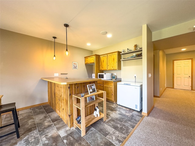 3640 Jack Dr, Missoula, MT 59803 - kitchen featuring white appliances, a peninsula, pendant lighting, brown cabinets, and light countertops