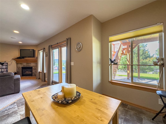 3640 Jack Dr, Missoula, MT 59803 - dining space featuring healthy amount of natural light, a tiled fireplace, recessed lighting, and stone finish floors