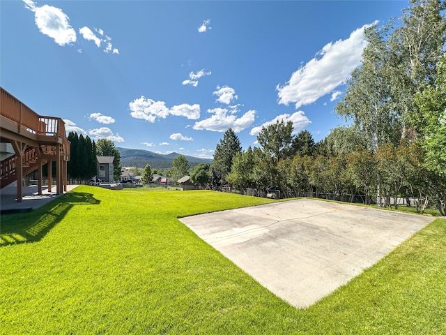 3640 Jack Dr, Missoula, MT 59803 - view of green lawn featuring a deck with mountain view and stairway
