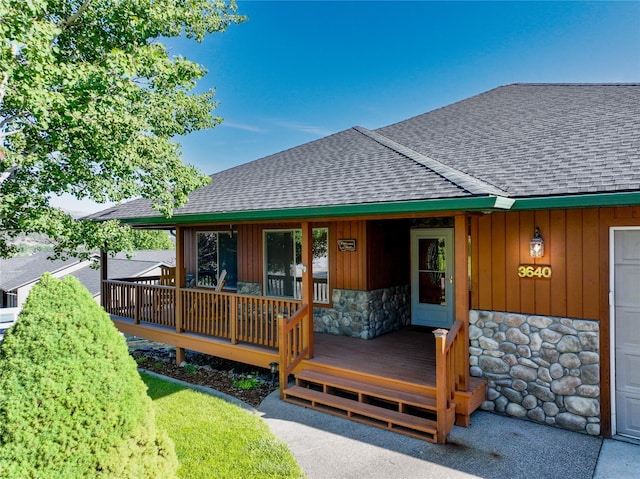 3640 Jack Dr, Missoula, MT 59803 - view of front of house featuring a shingled roof, stone siding, board and batten siding, and covered porch