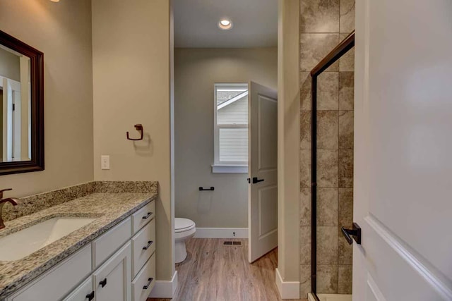 2909 Travis Ave, Helena, MT 59601 - bathroom featuring vanity, a shower stall, and wood finished floors