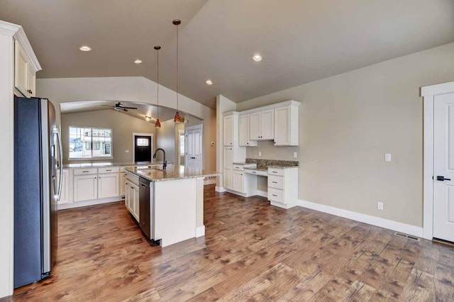 2909 Travis Ave, Helena, MT 59601 - kitchen with stainless steel appliances, lofted ceiling, ceiling fan, white cabinets, and light stone counters