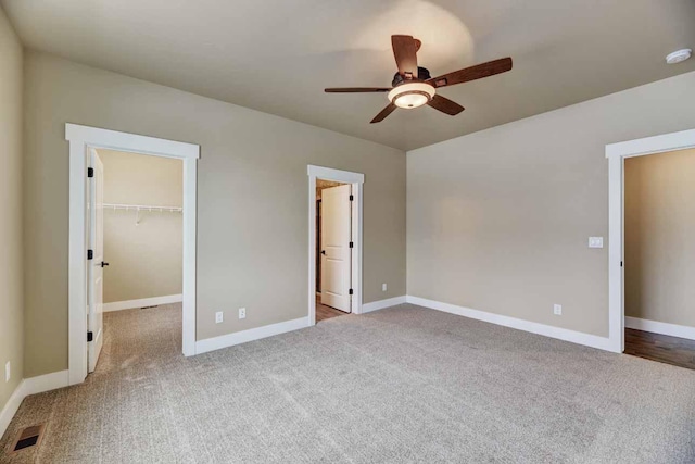 2909 Travis Ave, Helena, MT 59601 - unfurnished bedroom with carpet floors, a walk in closet, ceiling fan, and a closet