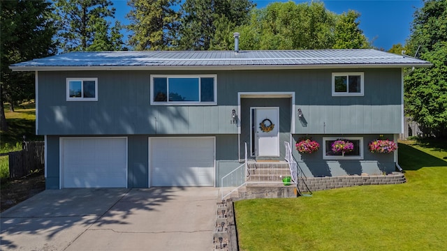 181 Ridgeway Dr, Lolo, MT 59847 - split foyer home with a front yard, a garage, concrete driveway, and a metal roof