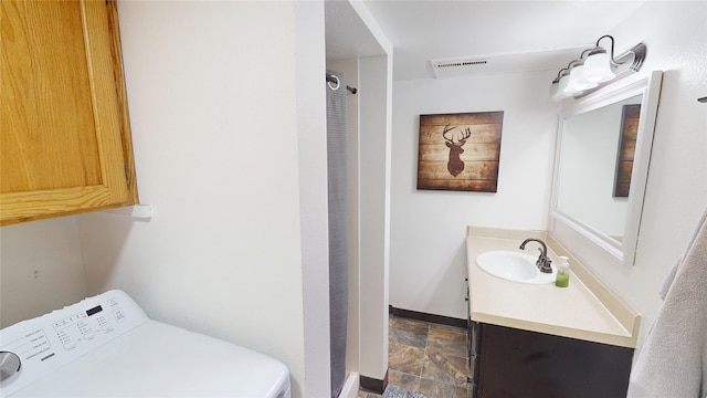 181 Ridgeway Dr, Lolo, MT 59847 - laundry room with washer / dryer and dark stone finish flooring