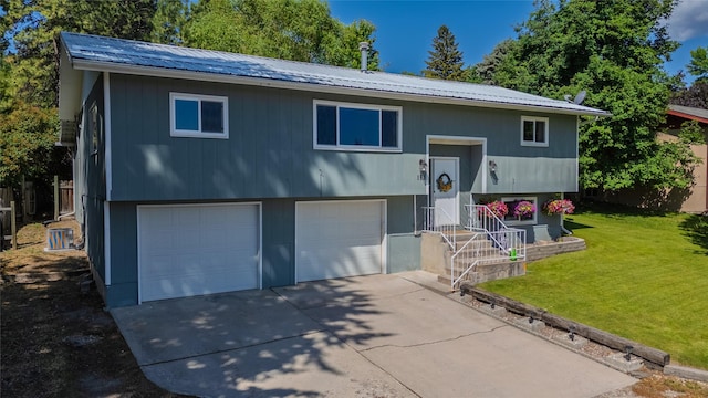 181 Ridgeway Dr, Lolo, MT 59847 - raised ranch with an attached garage, a front lawn, a metal roof, and concrete driveway