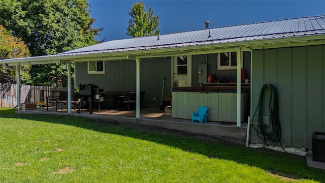 181 Ridgeway Dr, Lolo, MT 59847 - rear view of property with a hot tub, a patio, and a metal roof