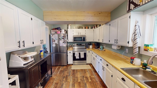 181 Ridgeway Dr, Lolo, MT 59847 - kitchen with appliances with stainless steel finishes, wood finished floors, white cabinetry, and light countertops
