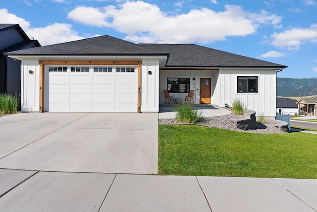 7070 Max Dr, Missoula, MT 59803 - modern farmhouse featuring board and batten siding, driveway, a garage, a front lawn, and roof with shingles