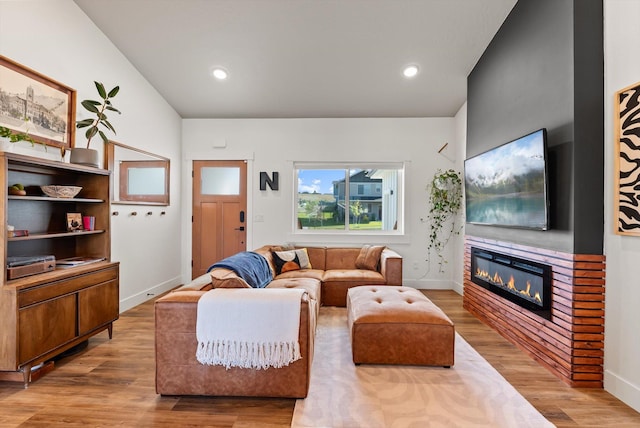 7070 Max Dr, Missoula, MT 59803 - living area featuring a glass covered fireplace, wood finished floors, and recessed lighting