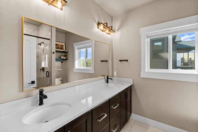 7070 Max Dr, Missoula, MT 59803 - full bathroom featuring double vanity, a shower stall, and tile patterned floors