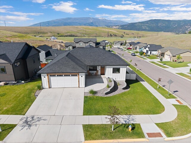 7070 Max Dr, Missoula, MT 59803 - view of front of house featuring a residential view, driveway, an attached garage, and a mountain view
