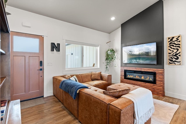 7070 Max Dr, Missoula, MT 59803 - living room featuring light wood-style floors, a glass covered fireplace, and recessed lighting