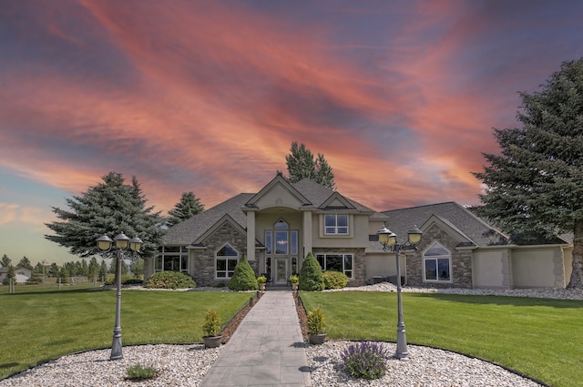 424 Saddle Ridge Rd, Hamilton, MT 59840 - traditional-style house with stone siding, a front yard, and stucco siding