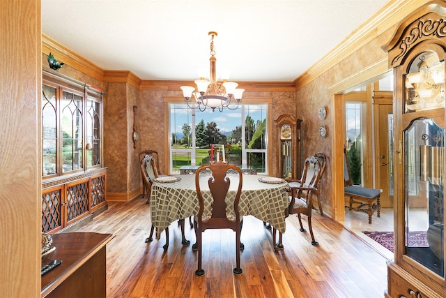424 Saddle Ridge Rd, Hamilton, MT 59840 - dining area featuring a chandelier, crown molding, and wood finished floors