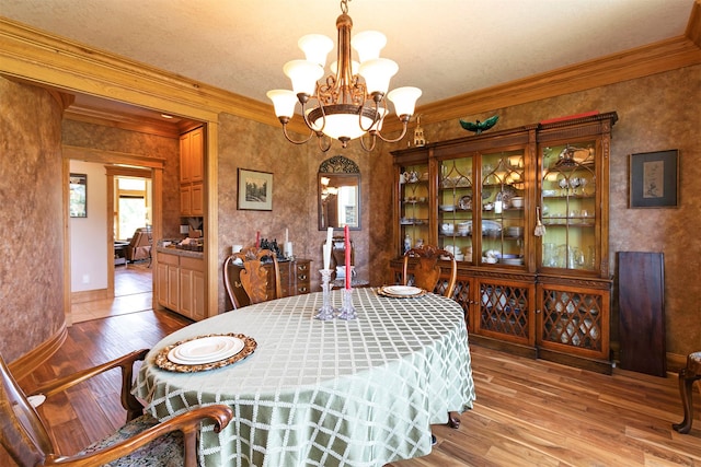 424 Saddle Ridge Rd, Hamilton, MT 59840 - dining space featuring ornamental molding, a chandelier, and wood finished floors