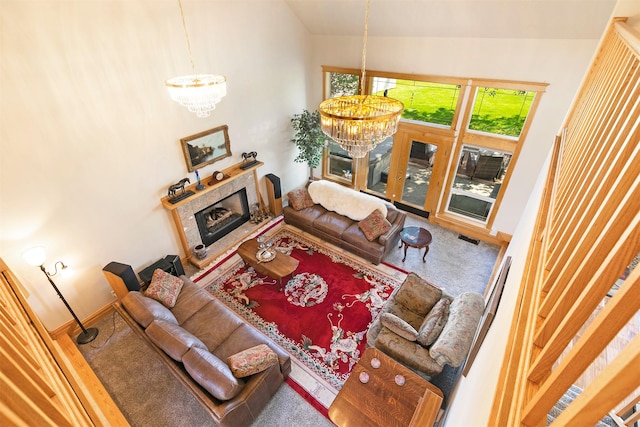 424 Saddle Ridge Rd, Hamilton, MT 59840 - carpeted living room with a chandelier, vaulted ceiling, and a tile fireplace