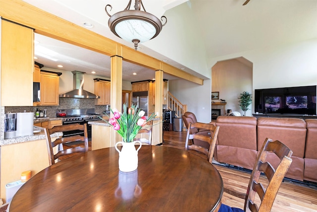 424 Saddle Ridge Rd, Hamilton, MT 59840 - dining room with light wood finished floors, stairs, recessed lighting, a fireplace, and ornate columns