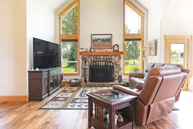 424 Saddle Ridge Rd, Hamilton, MT 59840 - living area with a fireplace, wood finished floors, plenty of natural light, and high vaulted ceiling