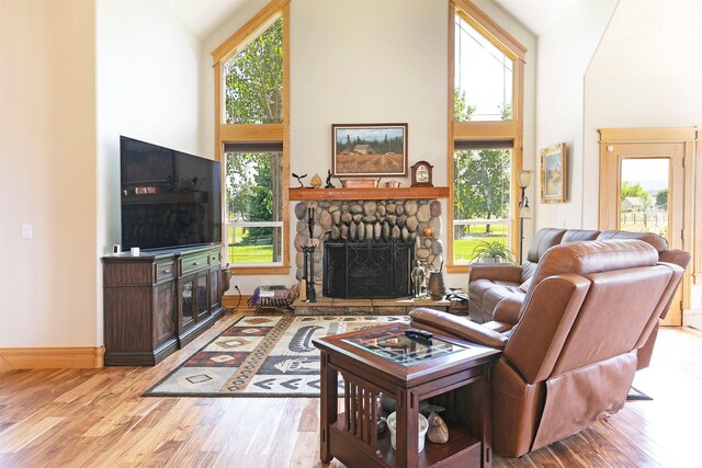 424 Saddle Ridge Rd, Hamilton, MT 59840 - living area with high vaulted ceiling, wood finished floors, a fireplace, and arched walkways