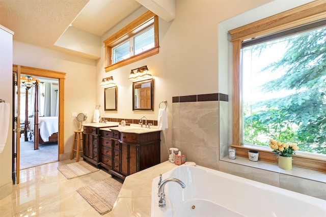 424 Saddle Ridge Rd, Hamilton, MT 59840 - bathroom featuring ensuite bathroom, double vanity, a whirlpool tub, and plenty of natural light