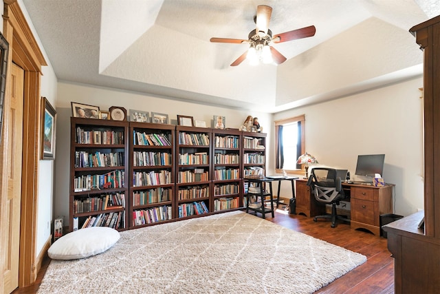 424 Saddle Ridge Rd, Hamilton, MT 59840 - office space with dark wood-style flooring, ceiling fan, a raised ceiling, a textured ceiling, and wall of books