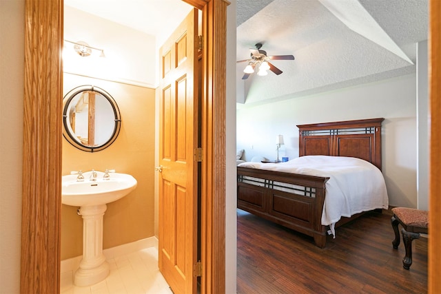 424 Saddle Ridge Rd, Hamilton, MT 59840 - bedroom featuring a textured ceiling, wood finished floors, and ceiling fan