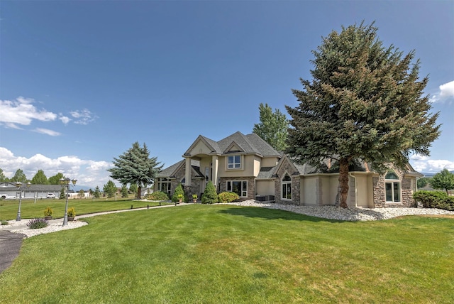 424 Saddle Ridge Rd, Hamilton, MT 59840 - view of front of home with stone siding, a front yard, and stucco siding