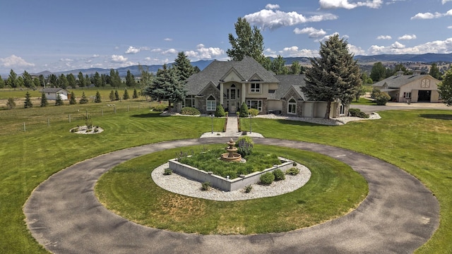 424 Saddle Ridge Rd, Hamilton, MT 59840 - view of front facade featuring curved driveway, stone siding, and a mountain view