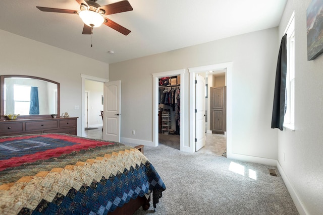 2110 Spring Wheat Loop, East Helena, MT 59635 - carpeted bedroom with multiple windows, a walk in closet, a ceiling fan, and a closet