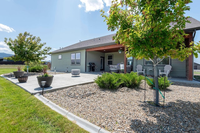 2110 Spring Wheat Loop, East Helena, MT 59635 - rear view of house with a patio and a lawn