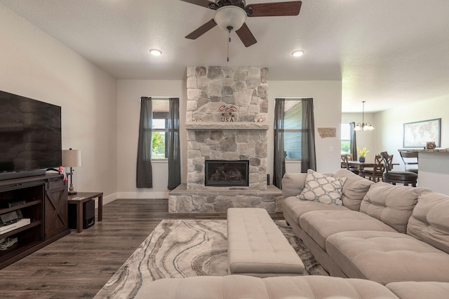 2110 Spring Wheat Loop, East Helena, MT 59635 - living area with a ceiling fan, dark wood finished floors, a fireplace, and a chandelier