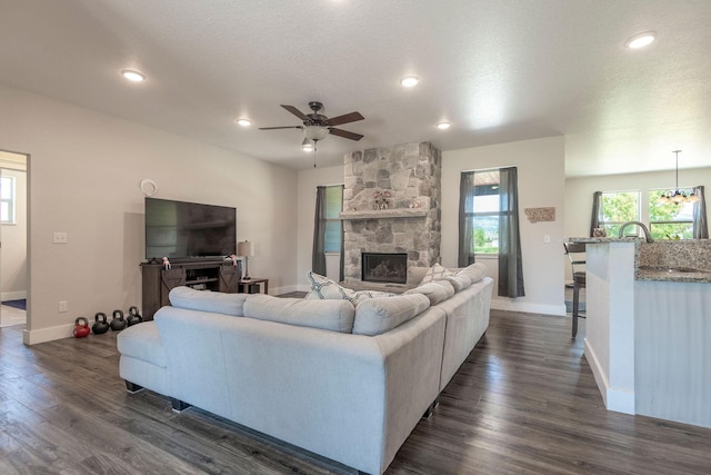 2110 Spring Wheat Loop, East Helena, MT 59635 - living room with a ceiling fan, a fireplace, dark wood-type flooring, recessed lighting, and a textured ceiling