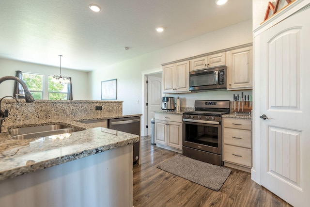 2110 Spring Wheat Loop, East Helena, MT 59635 - kitchen featuring appliances with stainless steel finishes, dark wood-style floors, recessed lighting, a chandelier, and light stone countertops