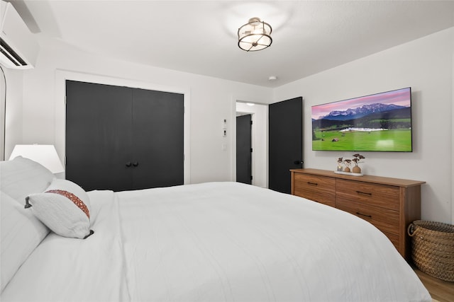 128 Mallard Loop, Whitefish, MT 59937 - bedroom with an AC wall unit and wood finished floors