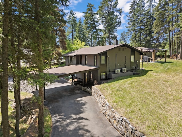 128 Mallard Loop, Whitefish, MT 59937 - view of front of house featuring asphalt driveway, a front yard, and a chimney