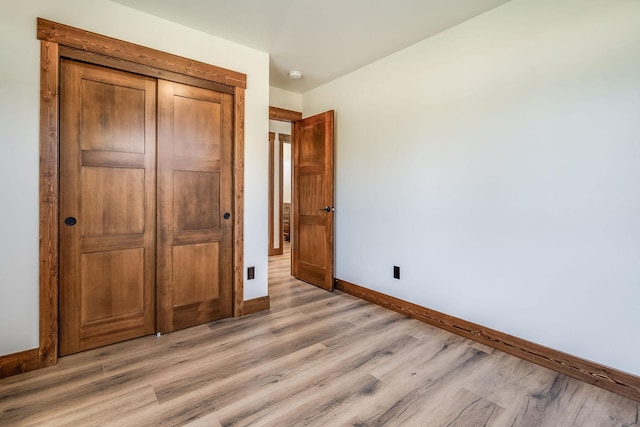309 Stanton St, Plains, MT 59859 - unfurnished bedroom featuring light wood-style flooring and a closet
