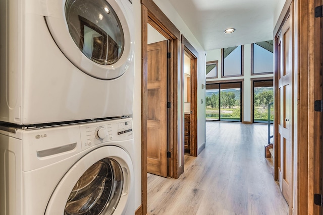 309 Stanton St, Plains, MT 59859 - laundry area with stacked washer and clothes dryer, light wood-style floors, and recessed lighting