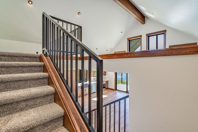 309 Stanton St, Plains, MT 59859 - staircase featuring beamed ceiling, wood finished floors, and high vaulted ceiling