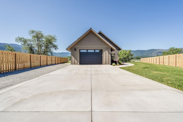 309 Stanton St, Plains, MT 59859 - view of front facade with a mountain view, a garage, board and batten siding, and concrete driveway