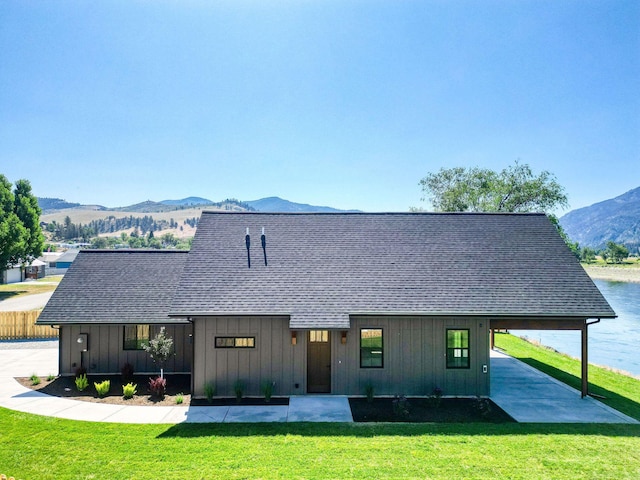 309 Stanton St, Plains, MT 59859 - modern inspired farmhouse with a mountain view, a front lawn, roof with shingles, and board and batten siding