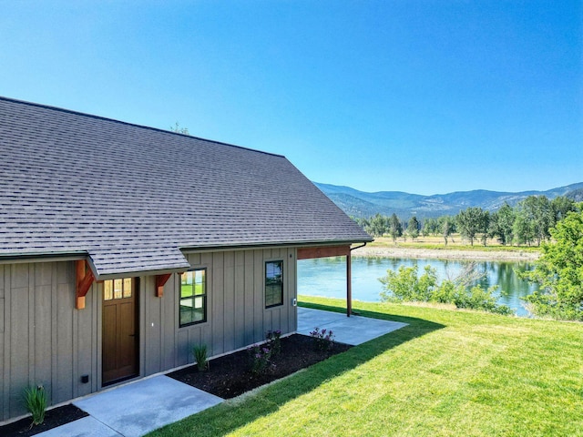 309 Stanton St, Plains, MT 59859 - view of side of property featuring a water and mountain view, a yard, board and batten siding, and a shingled roof