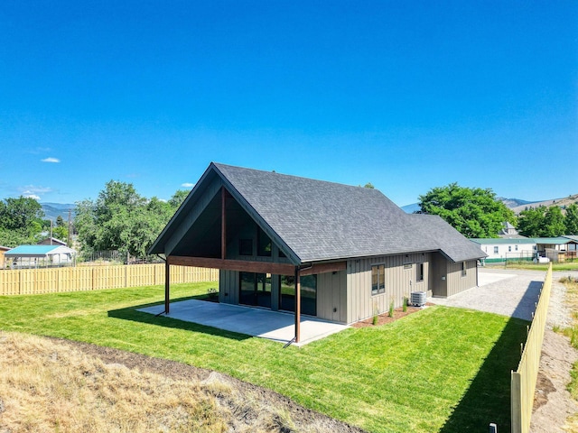 309 Stanton St, Plains, MT 59859 - back of property featuring roof with shingles, a mountain view, a patio area, and board and batten siding