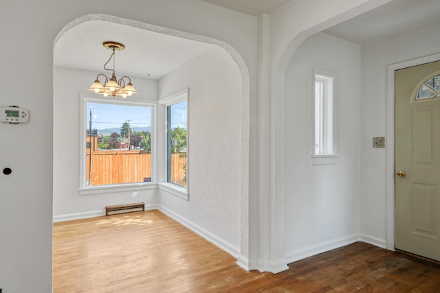 2515 S Higgins Ave, Missoula, MT 59801 - foyer entrance featuring a chandelier, arched walkways, and wood finished floors