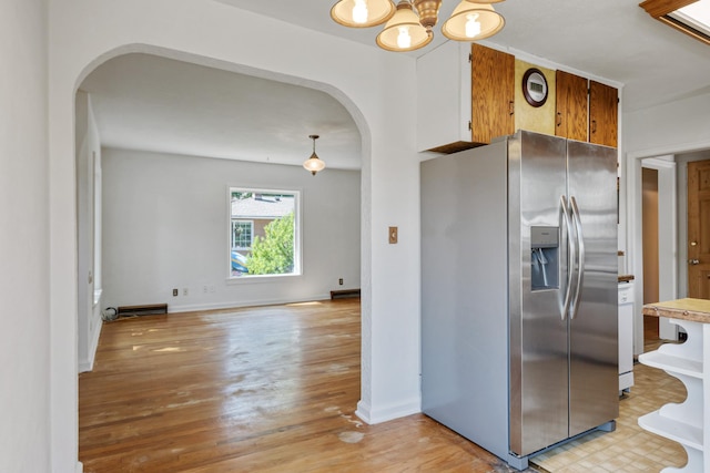 2515 S Higgins Ave, Missoula, MT 59801 - kitchen with stainless steel fridge with ice dispenser, arched walkways, light wood-style flooring, a chandelier, and brown cabinetry