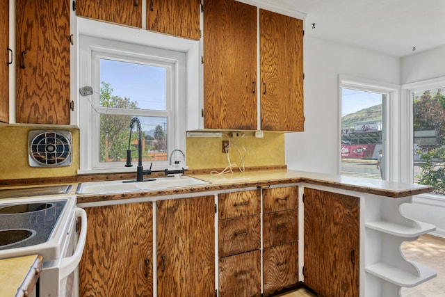 2515 S Higgins Ave, Missoula, MT 59801 - kitchen with light countertops, open shelves, white electric range oven, and a peninsula