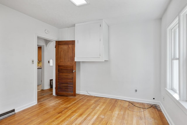 2515 S Higgins Ave, Missoula, MT 59801 - empty room featuring a baseboard radiator, light wood-style flooring, and a smoke detector