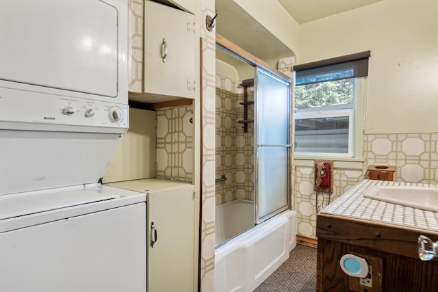 2515 S Higgins Ave, Missoula, MT 59801 - washroom featuring stacked washer / drying machine, tile walls, and wainscoting