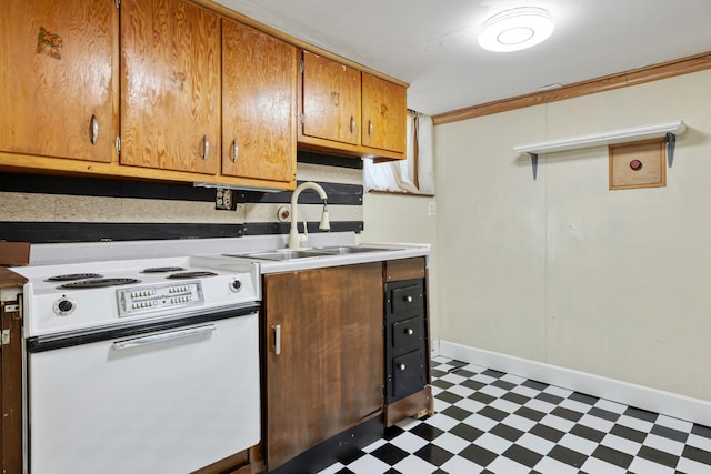 2515 S Higgins Ave, Missoula, MT 59801 - kitchen featuring white range with electric stovetop, tile patterned floors, crown molding, brown cabinetry, and light countertops